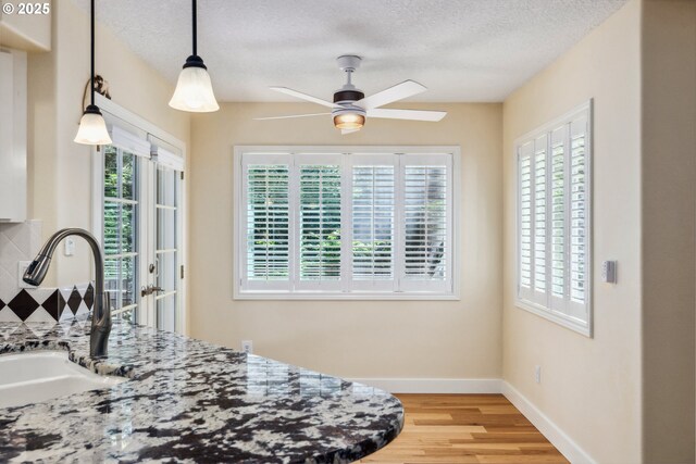 5364 Rosewood St, Lake Oswego, OR 97035 - kitchen with ceiling fan, light wood finished floors, a sink, a textured ceiling, and baseboards