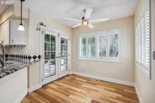 5364 Rosewood St, Lake Oswego, OR 97035 - doorway to outside with french doors, light wood-style flooring, a ceiling fan, and baseboards