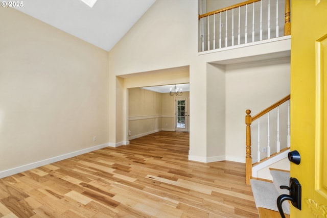 5364 Rosewood St, Lake Oswego, OR 97035 - entryway featuring wood finished floors, a chandelier, high vaulted ceiling, stairs, and baseboards