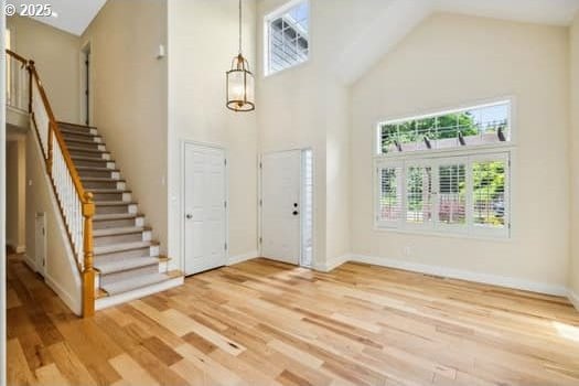 5364 Rosewood St, Lake Oswego, OR 97035 - foyer featuring a high ceiling, stairway, wood finished floors, and baseboards