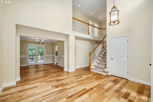 5364 Rosewood St, Lake Oswego, OR 97035 - unfurnished living room featuring a chandelier, wood finished floors, stairs, a high ceiling, and recessed lighting