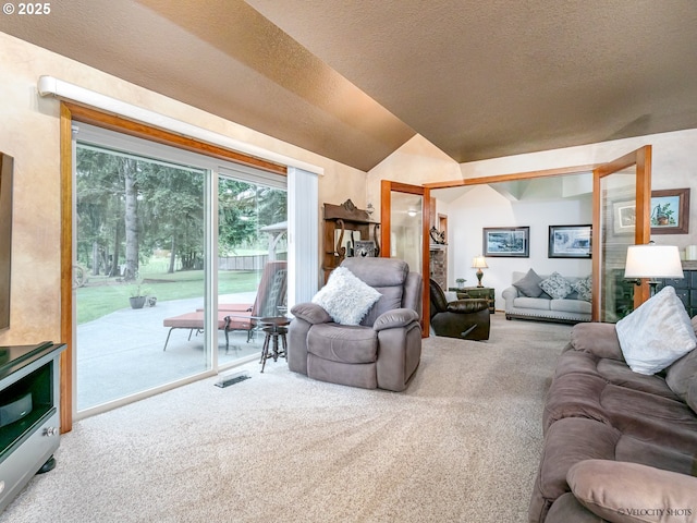 living area with lofted ceiling, carpet flooring, visible vents, and a textured ceiling