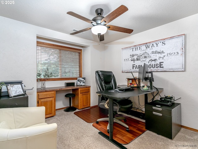 office area featuring a textured ceiling, baseboards, and a ceiling fan