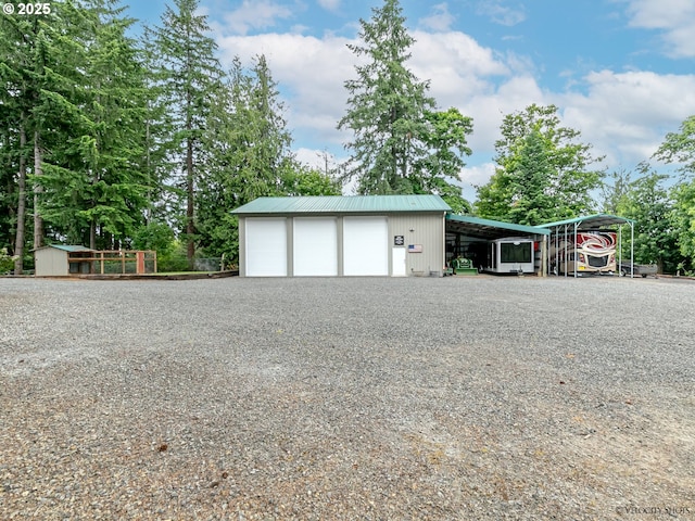 garage featuring gravel driveway and a detached garage