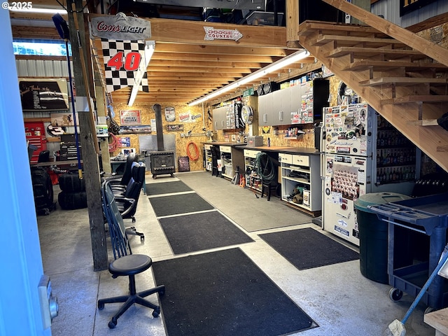 interior space featuring a workshop area and a wood stove