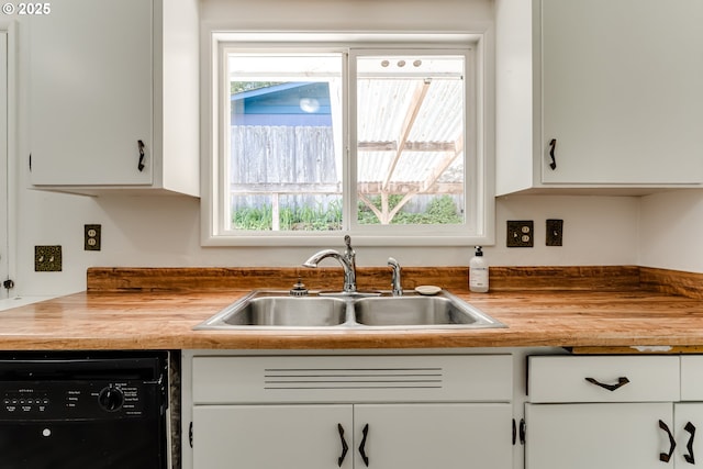 2220 Hayes St, Eugene, OR 97405 - kitchen featuring a sink, black dishwasher, butcher block counters, and white cabinetry