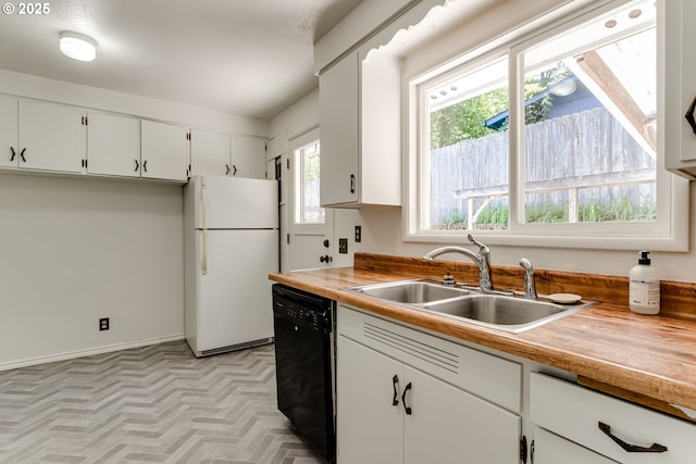 2220 Hayes St, Eugene, OR 97405 - kitchen with freestanding refrigerator, dishwasher, a sink, white cabinets, and butcher block countertops