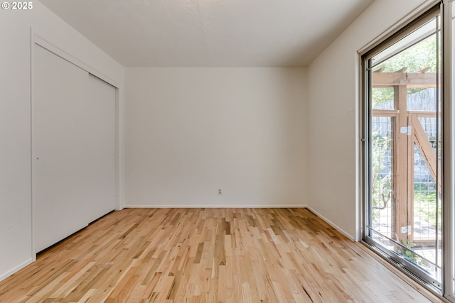 2220 Hayes St, Eugene, OR 97405 - unfurnished bedroom featuring multiple windows, light wood-type flooring, and baseboards