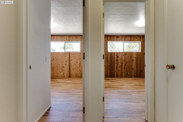 2220 Hayes St, Eugene, OR 97405 - corridor featuring plenty of natural light, wood finished floors, a textured ceiling, and wood walls
