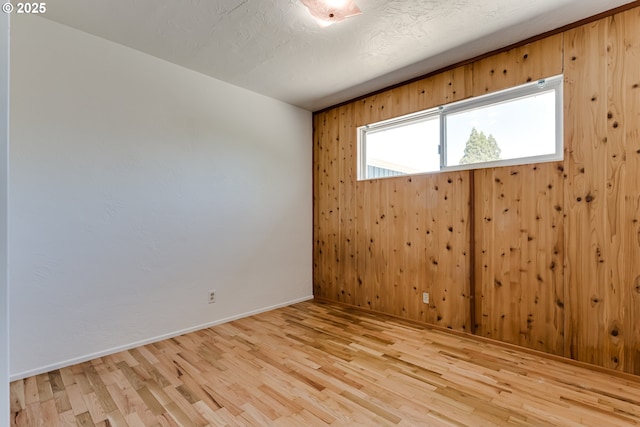 2220 Hayes St, Eugene, OR 97405 - empty room featuring wood finished floors, baseboards, and wooden walls
