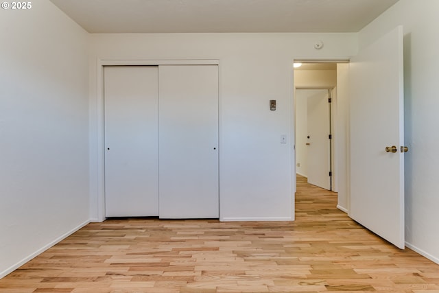 2220 Hayes St, Eugene, OR 97405 - unfurnished bedroom featuring light wood-style flooring, baseboards, and a closet