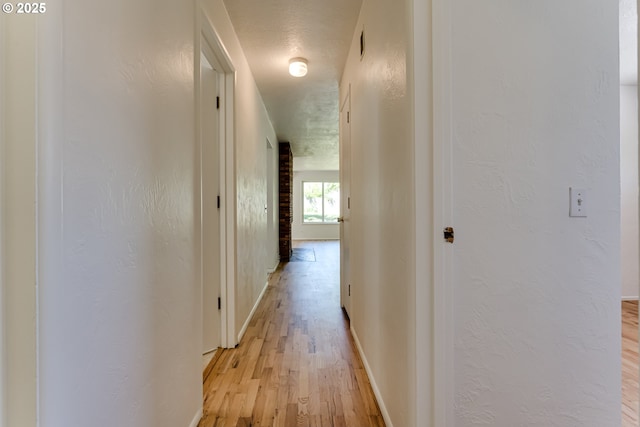 2220 Hayes St, Eugene, OR 97405 - hall featuring light wood finished floors, baseboards, and a textured wall