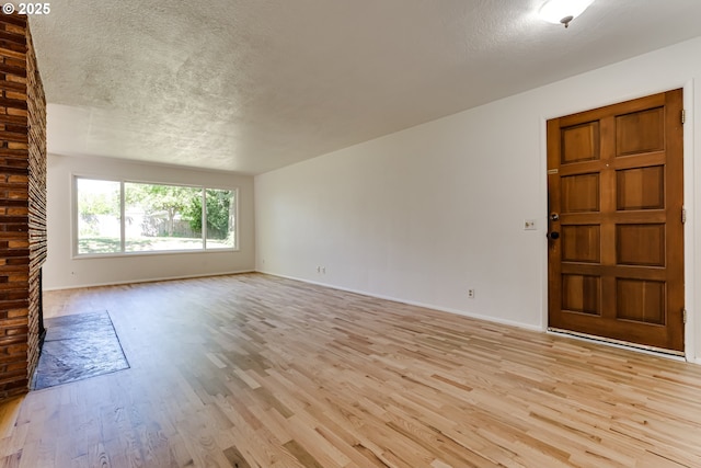2220 Hayes St, Eugene, OR 97405 - unfurnished room featuring a textured ceiling, light wood-style floors, and baseboards
