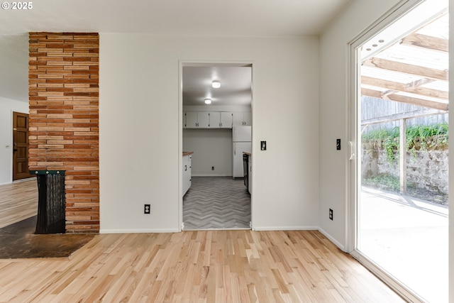 2220 Hayes St, Eugene, OR 97405 - unfurnished living room with light wood-style floors and baseboards