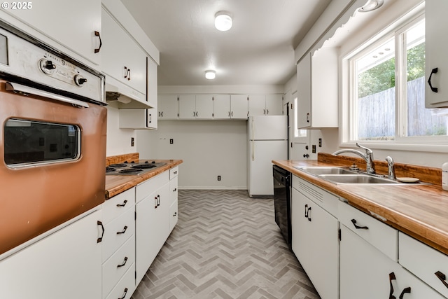 2220 Hayes St, Eugene, OR 97405 - kitchen with freestanding refrigerator, a sink, oven, stainless steel electric cooktop, and white cabinets