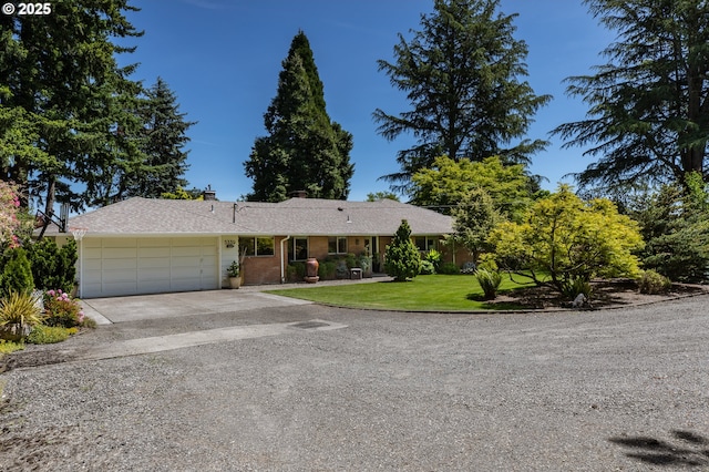 5339 SE Chase Rd, Gresham, OR 97080 - ranch-style house with concrete driveway, an attached garage, a front yard, a chimney, and brick siding