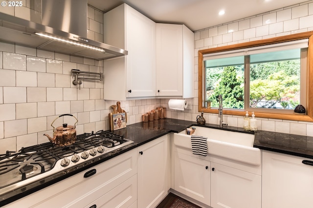 5339 SE Chase Rd, Gresham, OR 97080 - kitchen with wall chimney exhaust hood, white cabinets, stainless steel gas stovetop, decorative backsplash, and recessed lighting