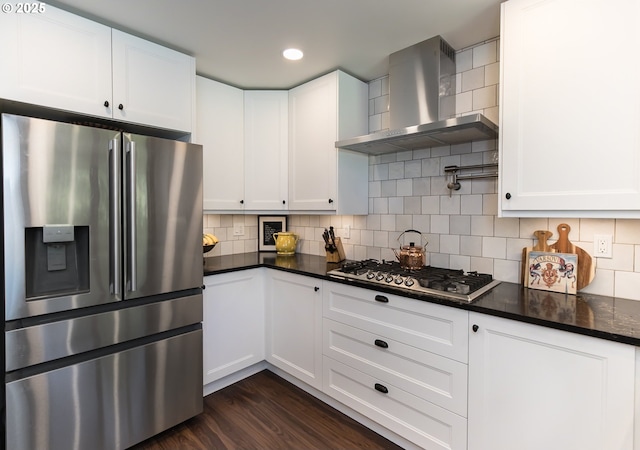 5339 SE Chase Rd, Gresham, OR 97080 - kitchen featuring appliances with stainless steel finishes, wall chimney range hood, dark wood finished floors, white cabinets, and recessed lighting