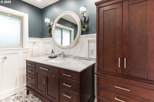5339 SE Chase Rd, Gresham, OR 97080 - bathroom with vanity, wainscoting, a decorative wall, and tile patterned flooring