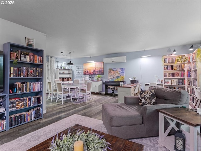 living room with hardwood / wood-style flooring and a wall mounted air conditioner