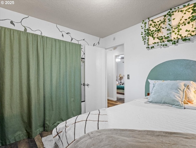 bedroom with wood-type flooring and a textured ceiling