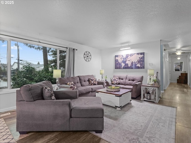 living room with hardwood / wood-style flooring and a textured ceiling