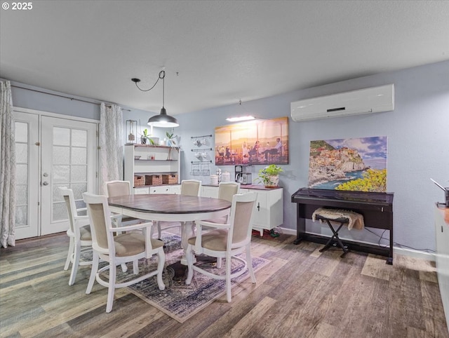 dining space featuring hardwood / wood-style floors and a wall unit AC