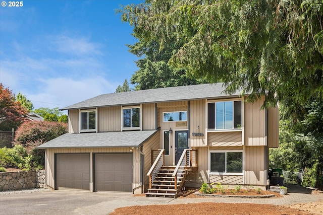 1625 SE Regner Rd, Gresham, OR 97080 - split foyer home with roof with shingles, an attached garage, and asphalt driveway