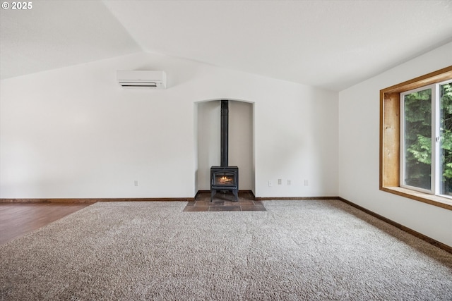 1625 SE Regner Rd, Gresham, OR 97080 - unfurnished living room with a wall unit AC, carpet floors, lofted ceiling, and a wood stove