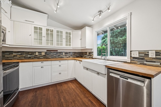 1625 SE Regner Rd, Gresham, OR 97080 - kitchen with butcher block counters, appliances with stainless steel finishes, lofted ceiling, tasteful backsplash, and glass insert cabinets