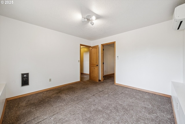 1625 SE Regner Rd, Gresham, OR 97080 - unfurnished room with an AC wall unit, carpet flooring, and a textured ceiling