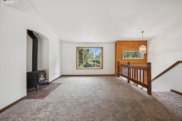 1625 SE Regner Rd, Gresham, OR 97080 - unfurnished living room with carpet, a wood stove, and a chandelier