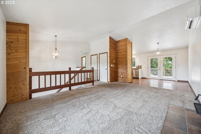 1625 SE Regner Rd, Gresham, OR 97080 - carpeted spare room with french doors, lofted ceiling, and a wall mounted air conditioner