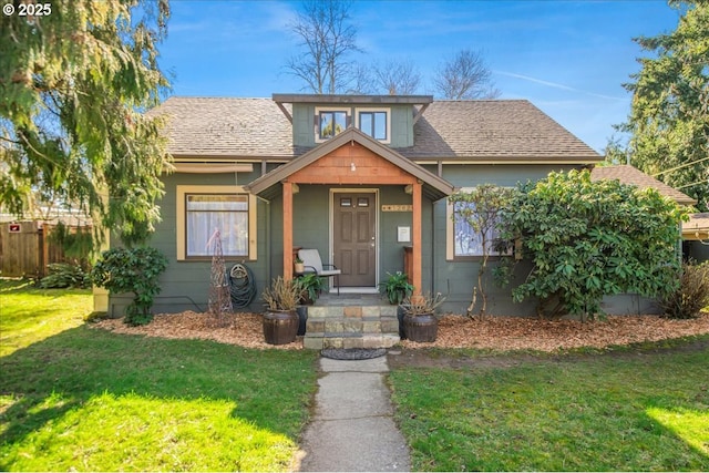 bungalow-style house featuring a shingled roof, a front yard, and fence