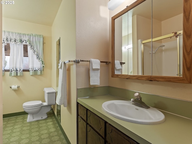 bathroom featuring an enclosed shower, vanity, toilet, and vaulted ceiling