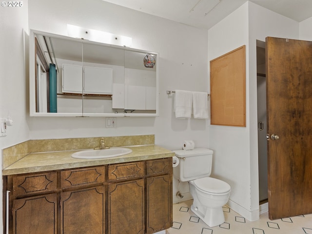 bathroom featuring vanity, toilet, and tile patterned floors