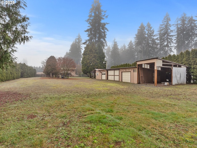 view of yard with an outbuilding and a garage