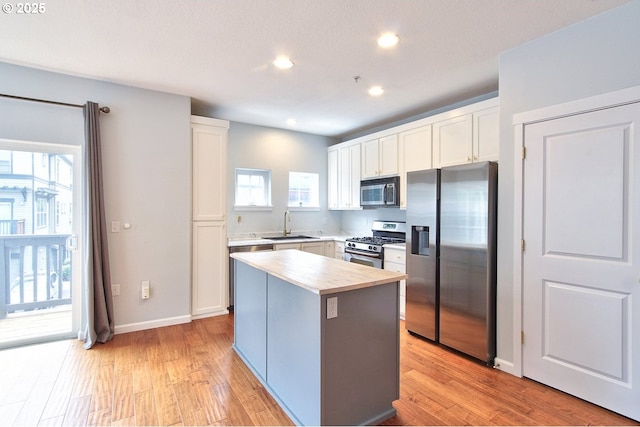 22860 SW Forest Creek Dr Unit 203, Sherwood, OR 97140 - kitchen featuring appliances with stainless steel finishes, white cabinets, butcher block countertops, recessed lighting, and light wood finished floors