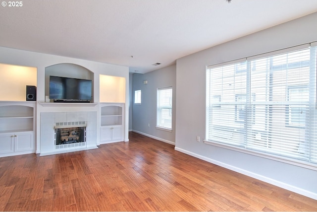 22860 SW Forest Creek Dr Unit 203, Sherwood, OR 97140 - unfurnished living room with wood finished floors and a fireplace