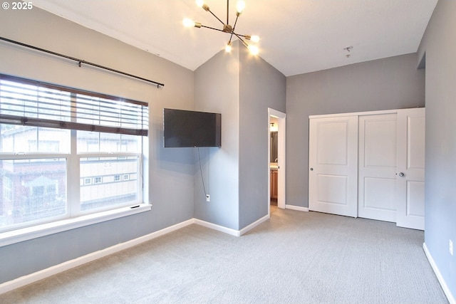 22860 SW Forest Creek Dr Unit 203, Sherwood, OR 97140 - unfurnished bedroom with a chandelier, carpet floors, multiple windows, and vaulted ceiling