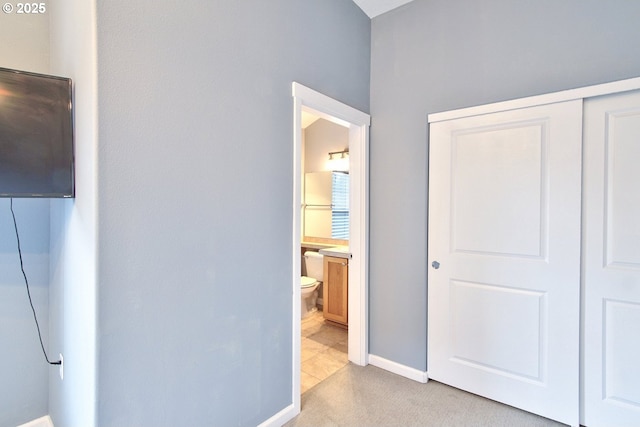 22860 SW Forest Creek Dr Unit 203, Sherwood, OR 97140 - unfurnished bedroom featuring a closet, light colored carpet, and ensuite bath