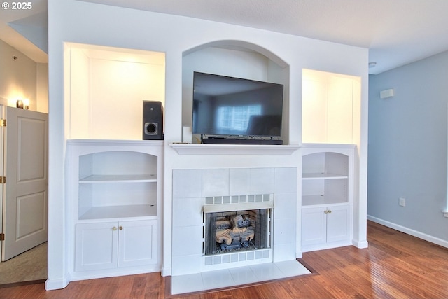 22860 SW Forest Creek Dr Unit 203, Sherwood, OR 97140 - living area featuring wood finished floors, a tiled fireplace, and built in features