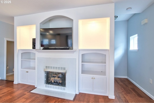22860 SW Forest Creek Dr Unit 203, Sherwood, OR 97140 - unfurnished living room with wood finished floors, built in features, and a tile fireplace