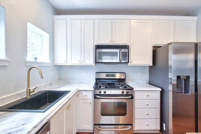 22860 SW Forest Creek Dr Unit 203, Sherwood, OR 97140 - kitchen featuring stainless steel appliances, white cabinets, and light stone counters