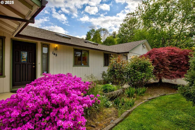 exterior space featuring roof with shingles