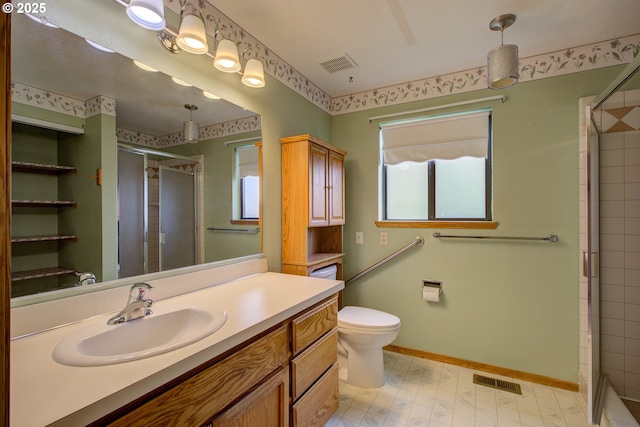 full bathroom featuring vanity, a shower stall, toilet, and visible vents