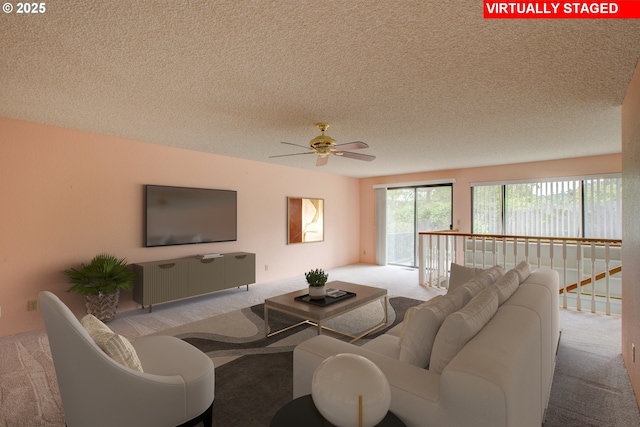 carpeted living area with ceiling fan and a textured ceiling