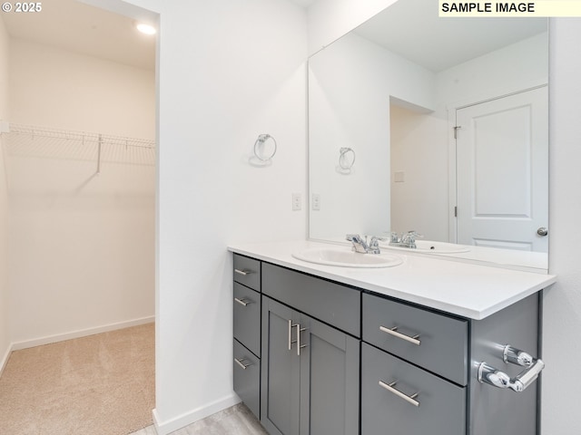 5416 NE 66th Pl, Vancouver, WA 98661 - bathroom with vanity, a walk in closet, and baseboards