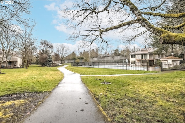 surrounding community featuring a pool and a yard