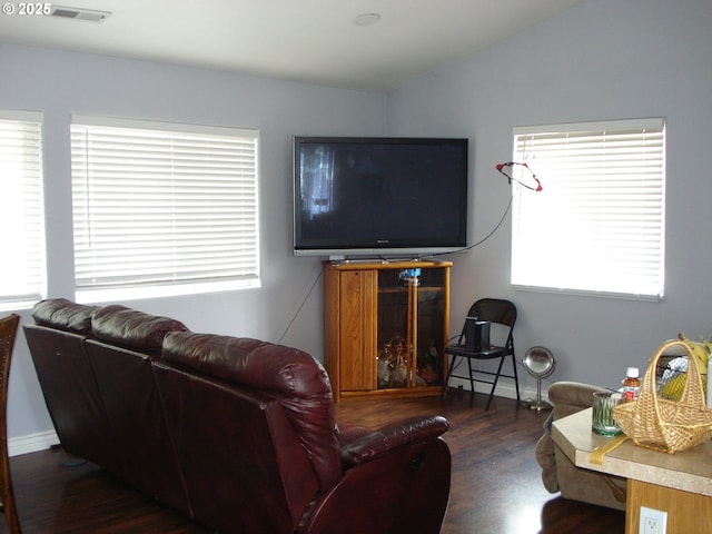 131 NW Makah Ct, Roseburg, OR 97471 - living room featuring wood finished floors, vaulted ceiling, plenty of natural light, and baseboards